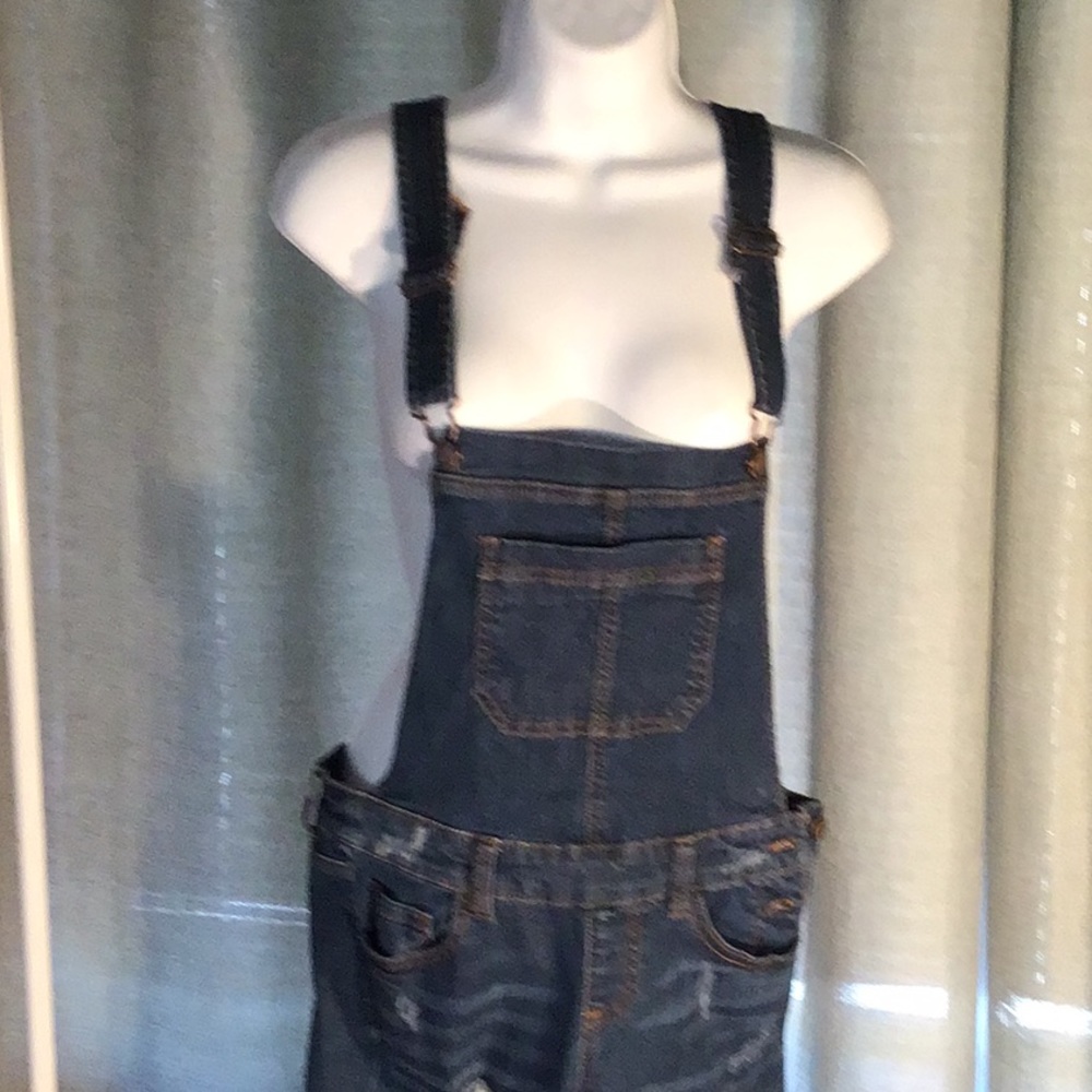 Women’s overalls jean fabric worn holes on legs